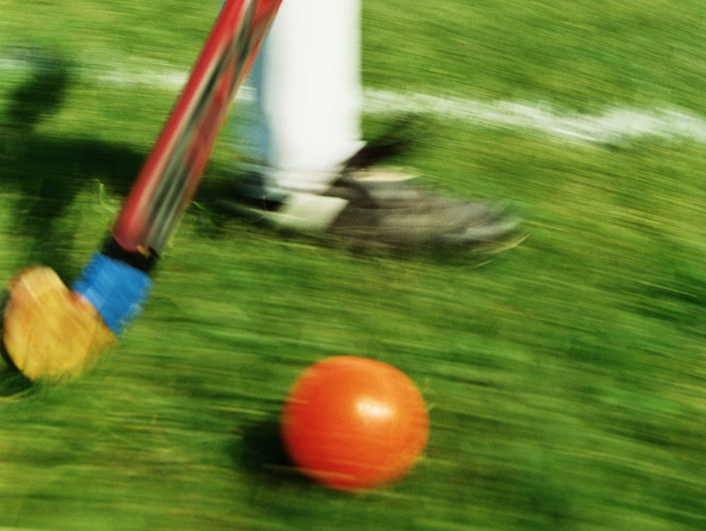 Girl playing field hockey (blurred motion)
