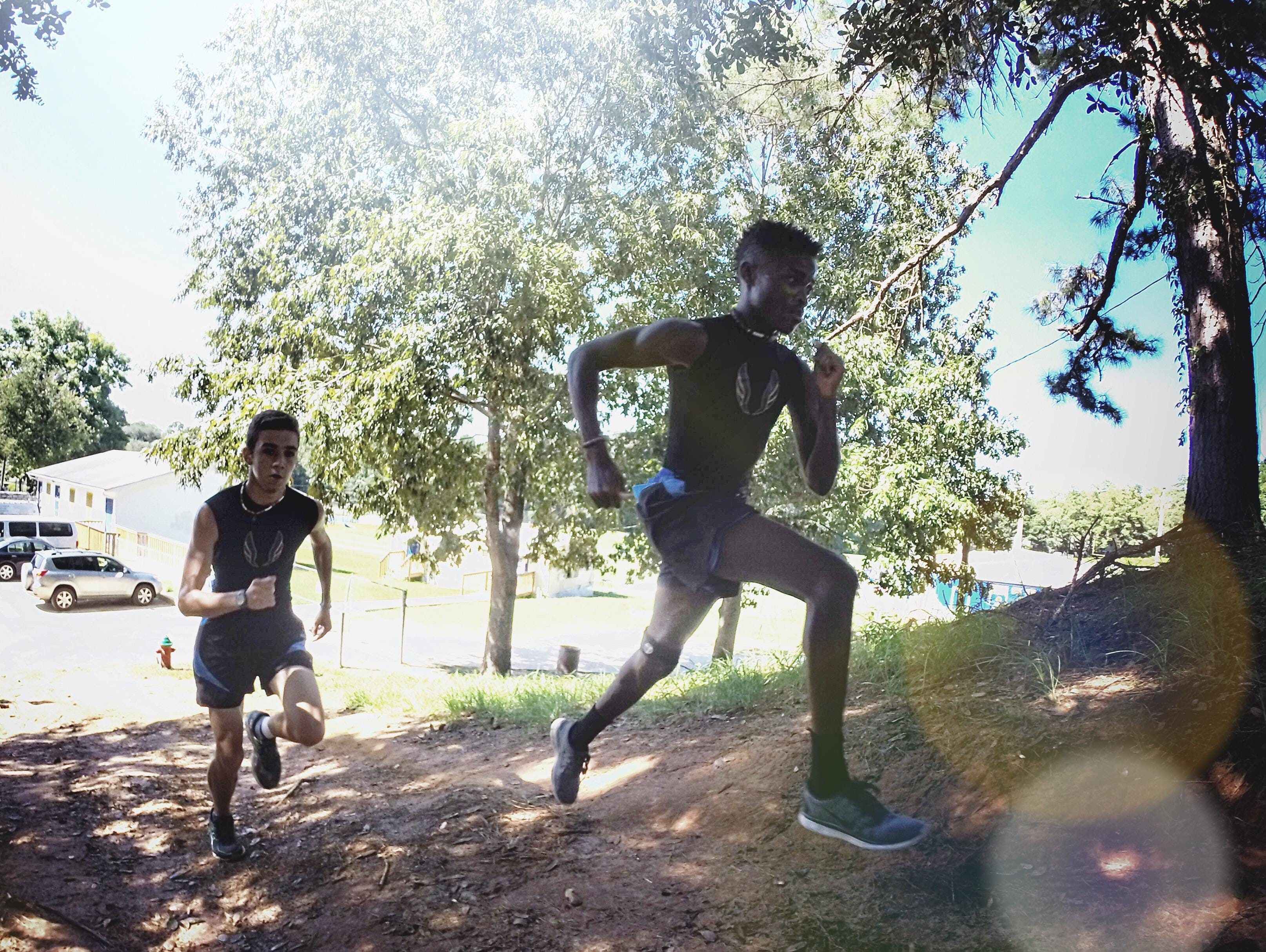 Rickards’ campus contains a large hill to traverse on a 3-mile loop that Rickards seniors Solomon Stevens (front) and Evan Garrison run as a warm-up prior to every cross country practice.