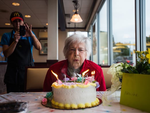 Nadine Baum blows out the candles on her birthday cake