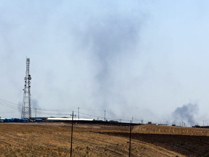 Smoke billows after an airstrike near a dam in Mosul, Iraq, as Kurdish forces battle for control.