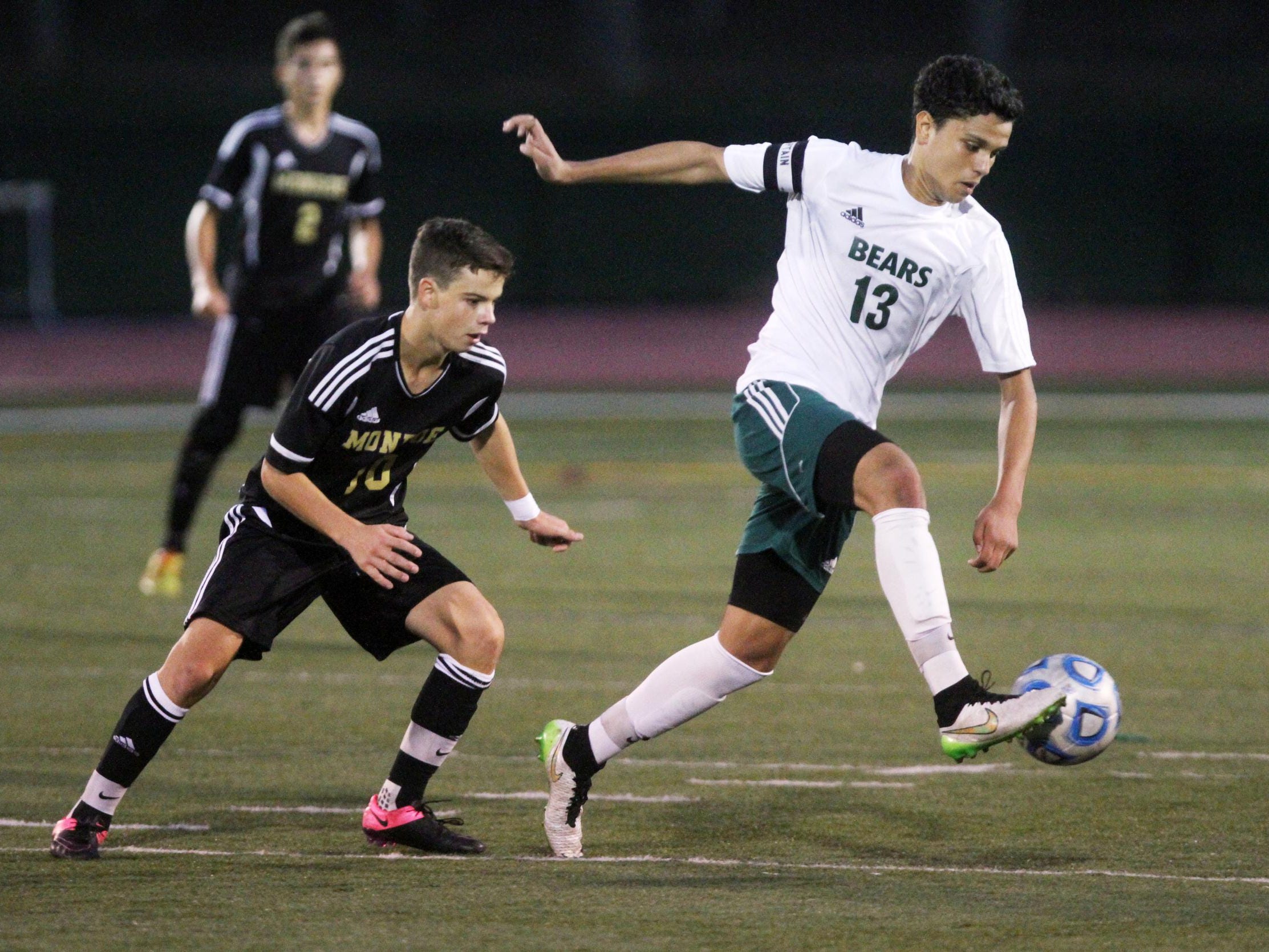 East Brunswick's Mohamed Fquihi kicks in front of Monroe's Alex Fernandez on Thursday in East Brunswick.