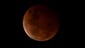 epa04436884 The Moon is seen glowing red during a total