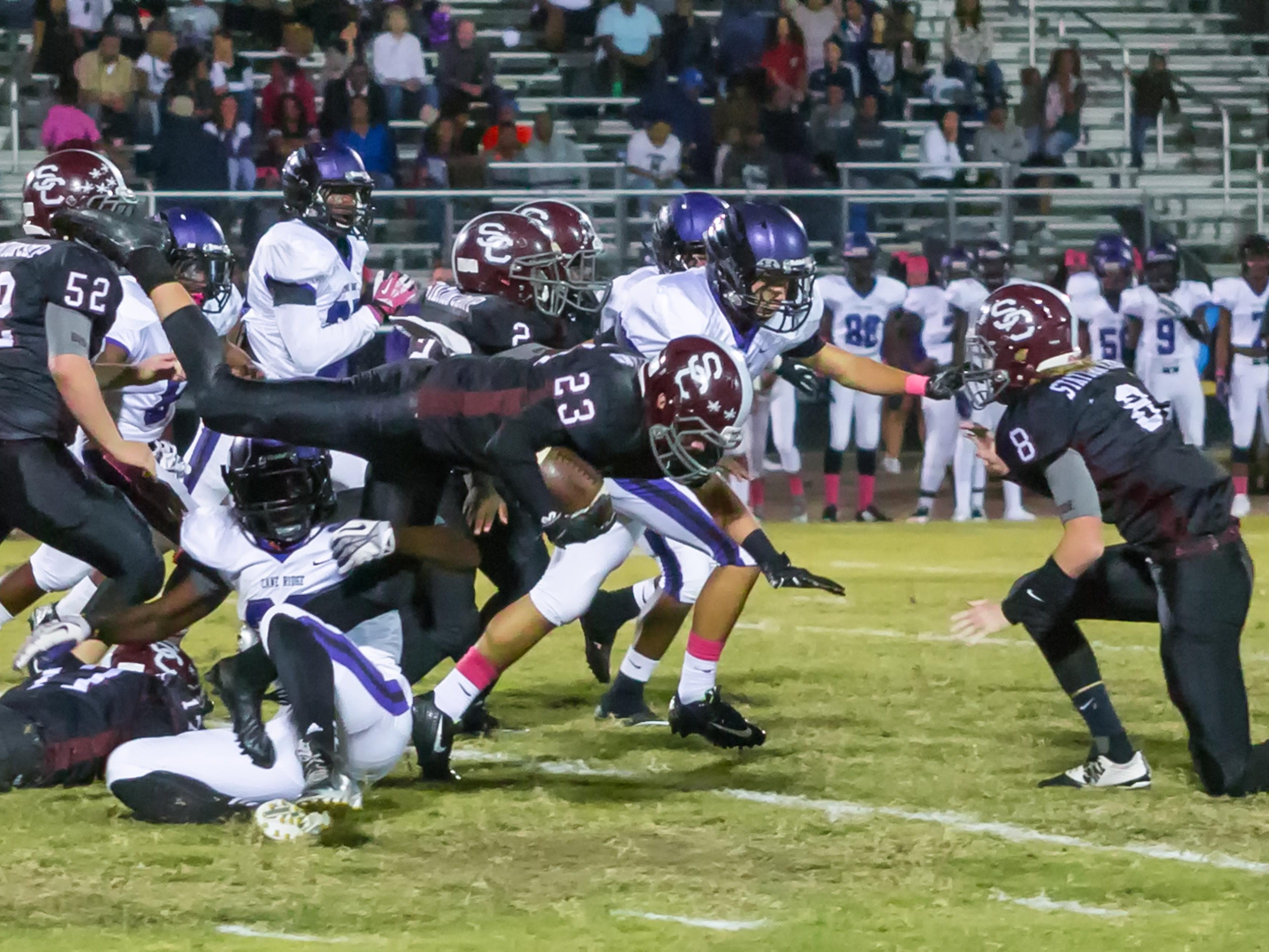 Station Camp High senior running back Aaron Bristol gets tripped up while carrying the football.