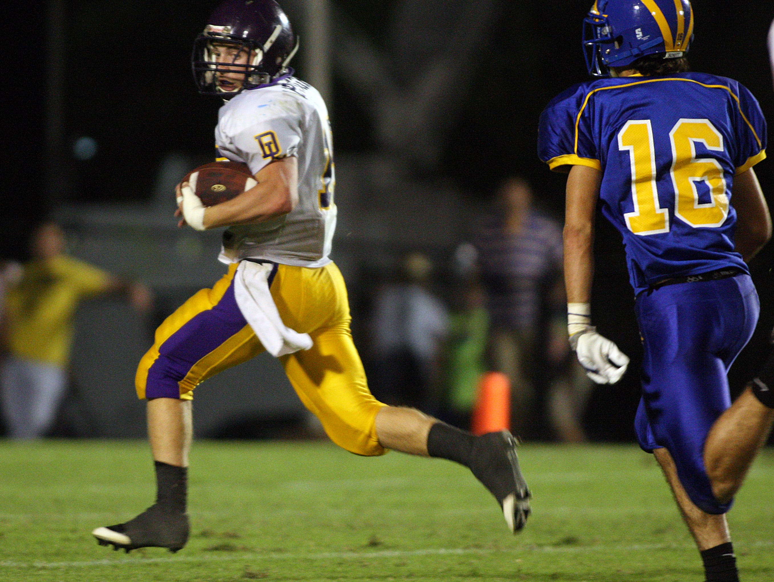 Lipscomb's Michael Mascol looks behind him while running in a touchdown against Goodpasture during a 2010 contest.