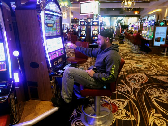 Anthony Palermo, of Rochester, plays a slot machine