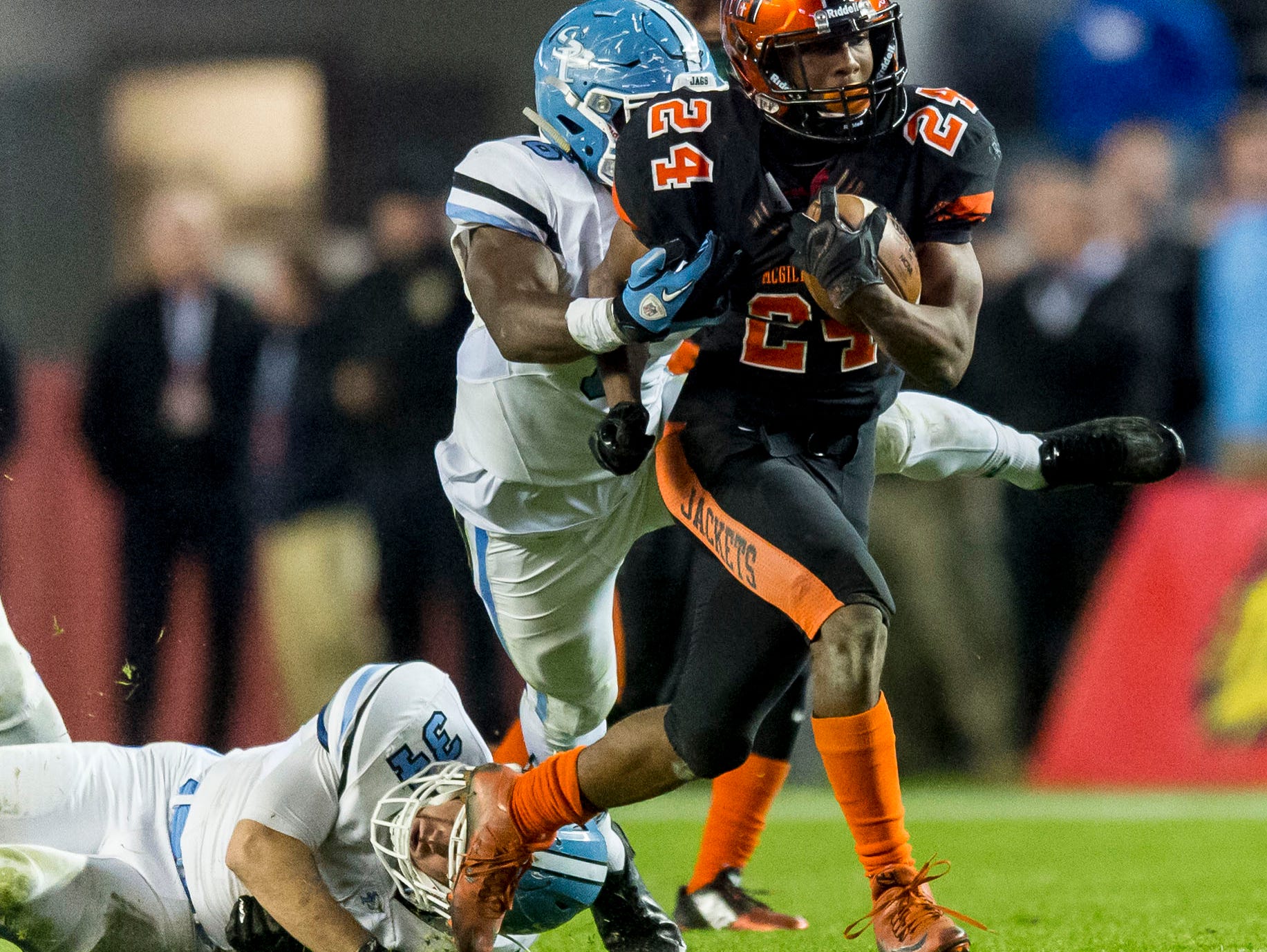 McGill-Toolen's Terrell Kennedy sheds two tacklers on the way to a 54-yard touchdowns in the second quarter of the Yellow Jackets' 14-12 win over Spain Park for the 7A championship Wednesday.
