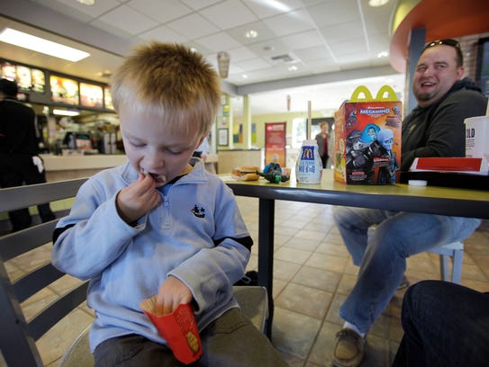 Henry Tonts, 3, of Hayward, Calif., eats french fries