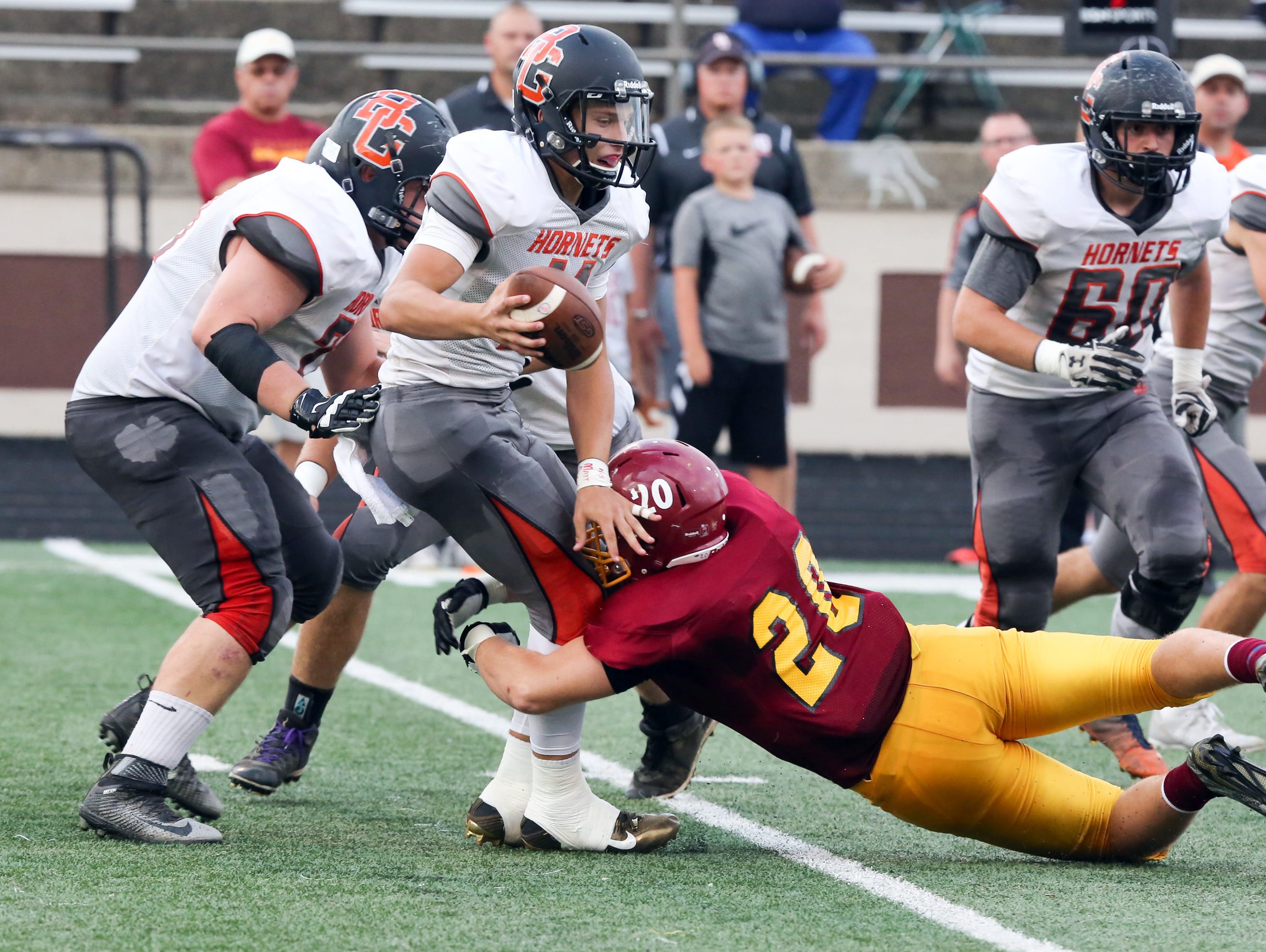 Scecina's Collin Connor wraps up Beech Grove QB Chase Andries Friday night.