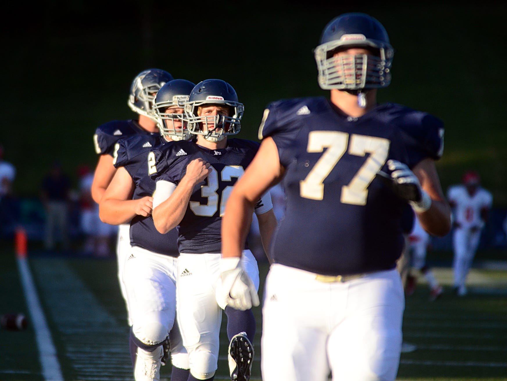Pope John Paul II players Jake Motz (77), Drew Bledsoe (32) and Daniel Leonard go through pregame stretches prior to a game earlier this season. The Knights, fresh off their first-ever victory over Baylor, host McCallie on Friday.