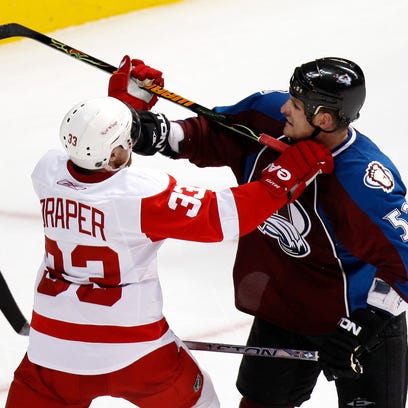 Detroit's Kris Draper and Colorado's Adam Foote mix