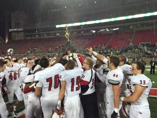 La Salle players hold up the state championship trophy.