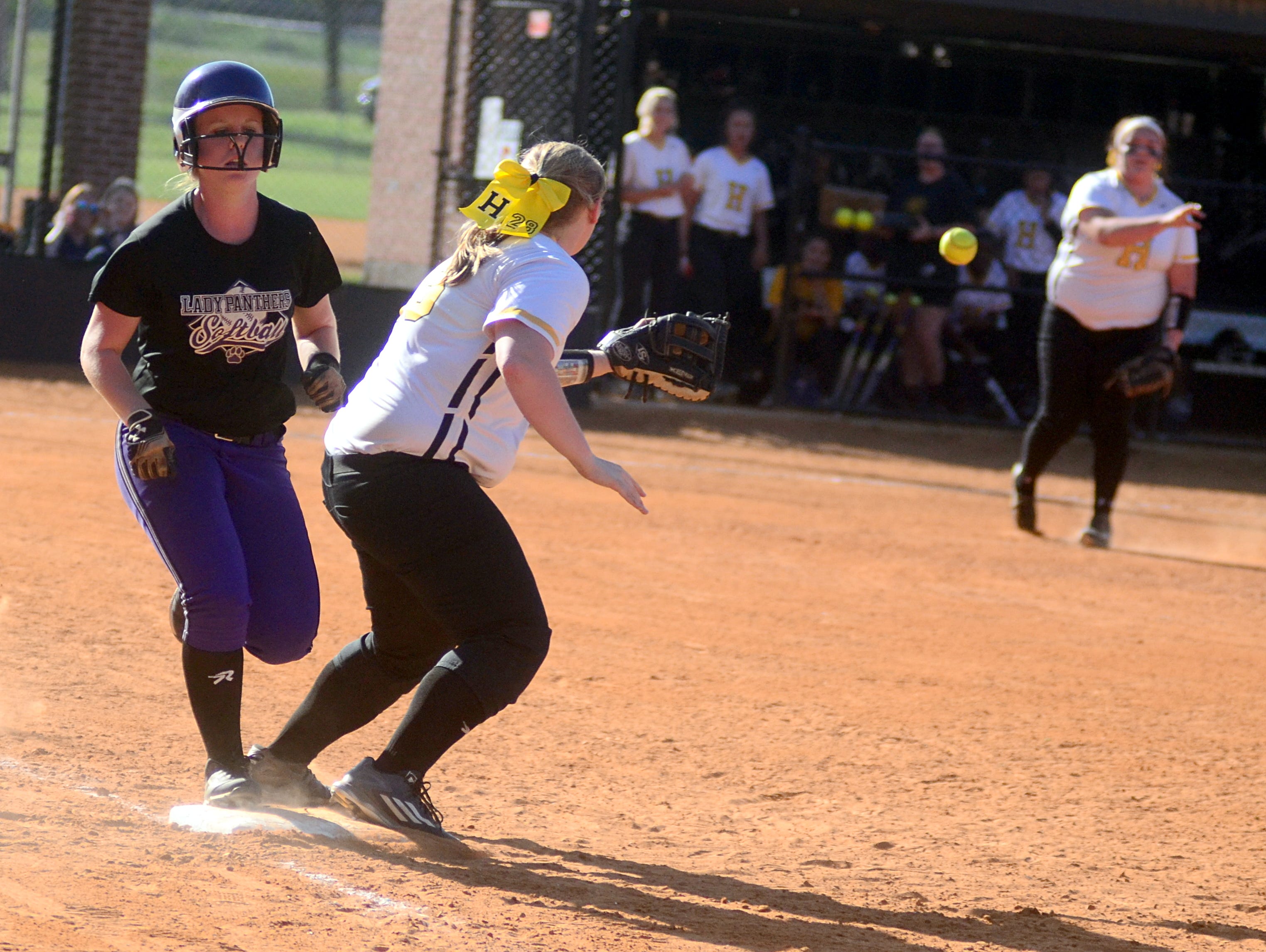 Portland High senior Keely McGee outruns s a throw from Hendersonville senior Carley Carlisle (right) to junior first baseman Annsley Kalamon during fourth-inning action.
