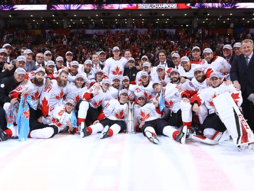 Team Canada players pose for a team photo after defeating