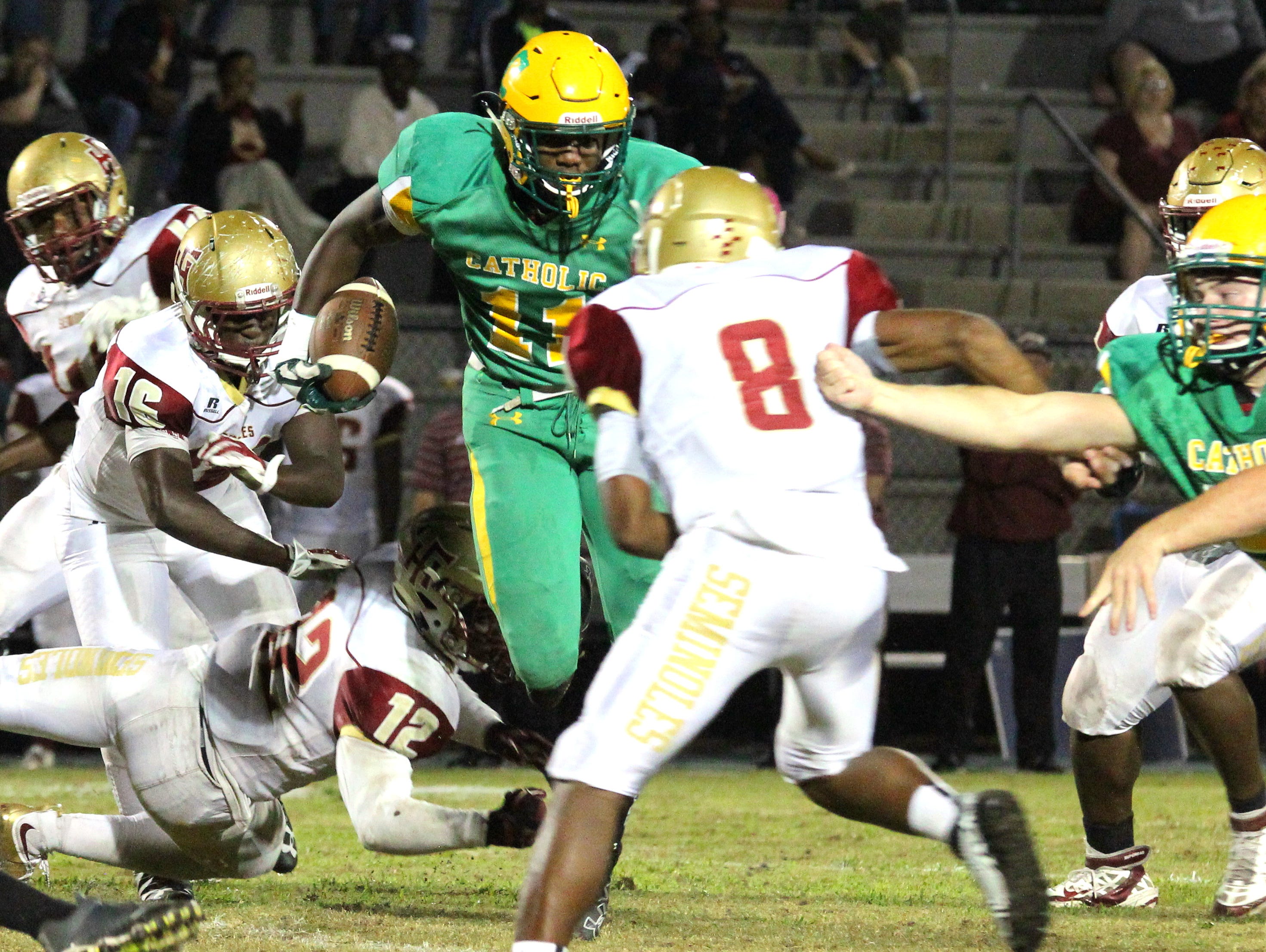 Catholic's Kerrick Teamer carries the ball in the second half.