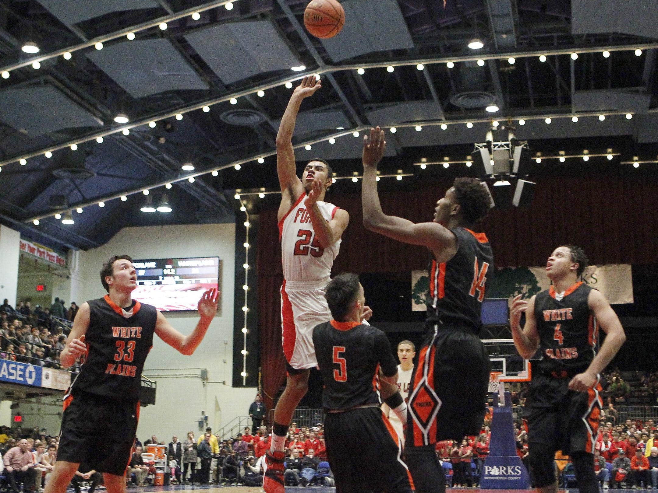Fox Lane’s Alex Olsen drives past White Plains’ Luis Cartagena during a Class AA semifinal at the County Center in White Plains on Friday.