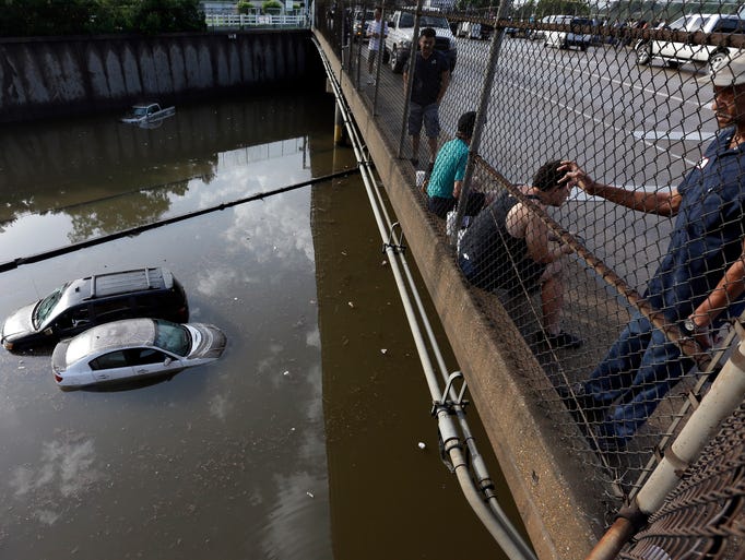 Cars sit in floodwaters along Interstate 45 after heavy