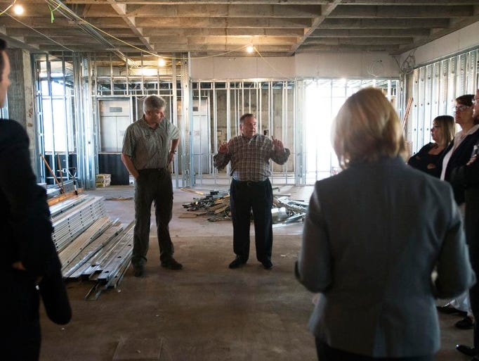 The Collider CEO Bill Dean, center, speaks with members