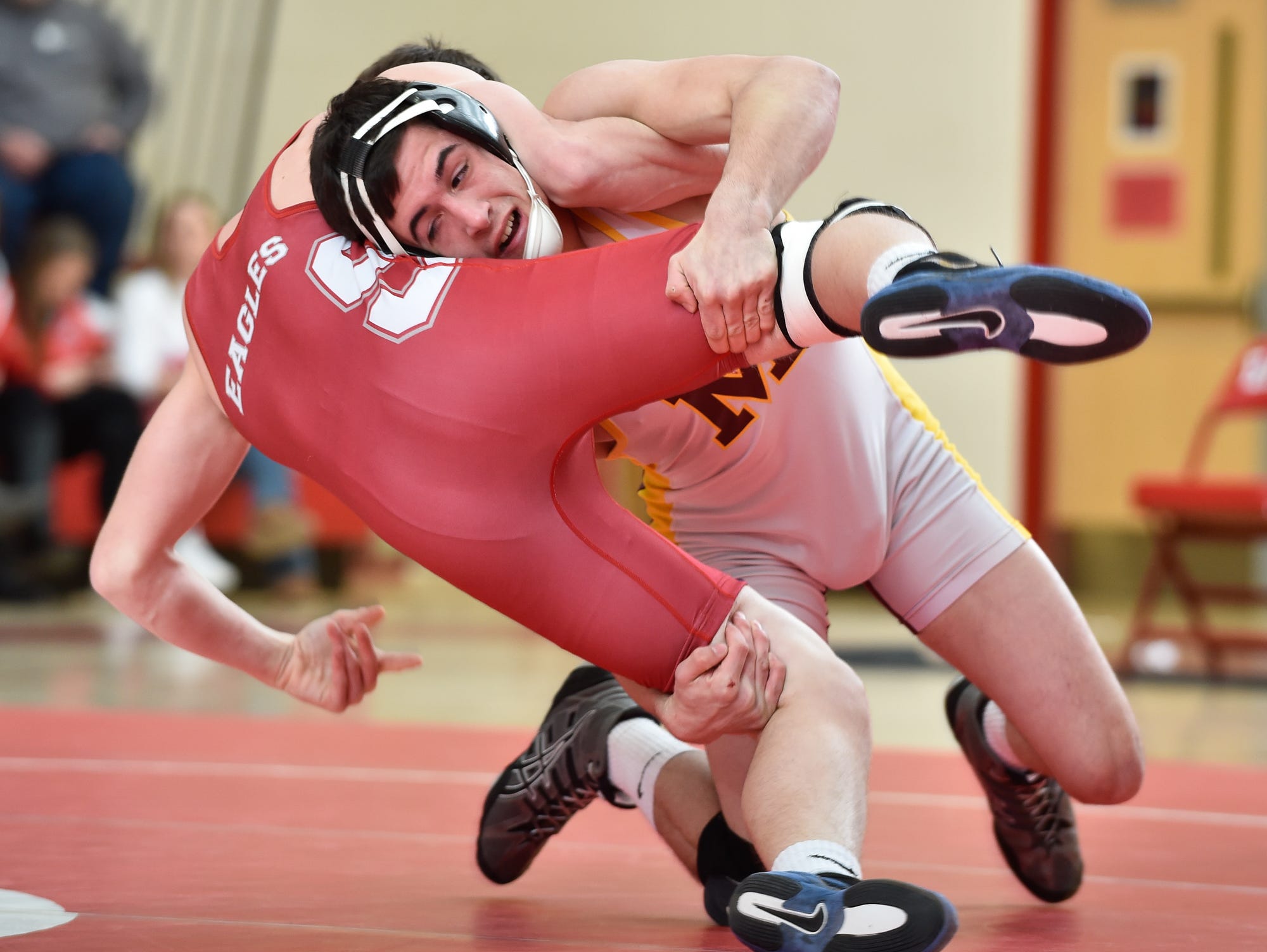 Milford's Barton Dalious, right muscles Smyrna's Tanner Mullen to the mat in the 145 pound match at Smyrna High School.