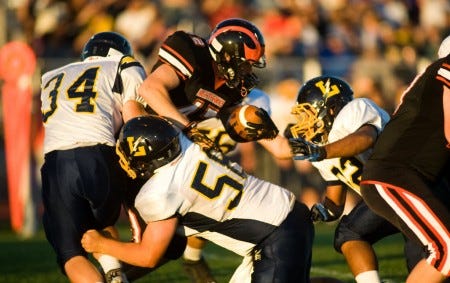 Littlestown's Zach Brown (34) and Kevin Billard (58) take down Hanover's Brad Irvin during Friday's game. The Thunderbolts won, 49-22. (GameTimePA.com -- Clare Becker) ID=75291178 ID=75291178