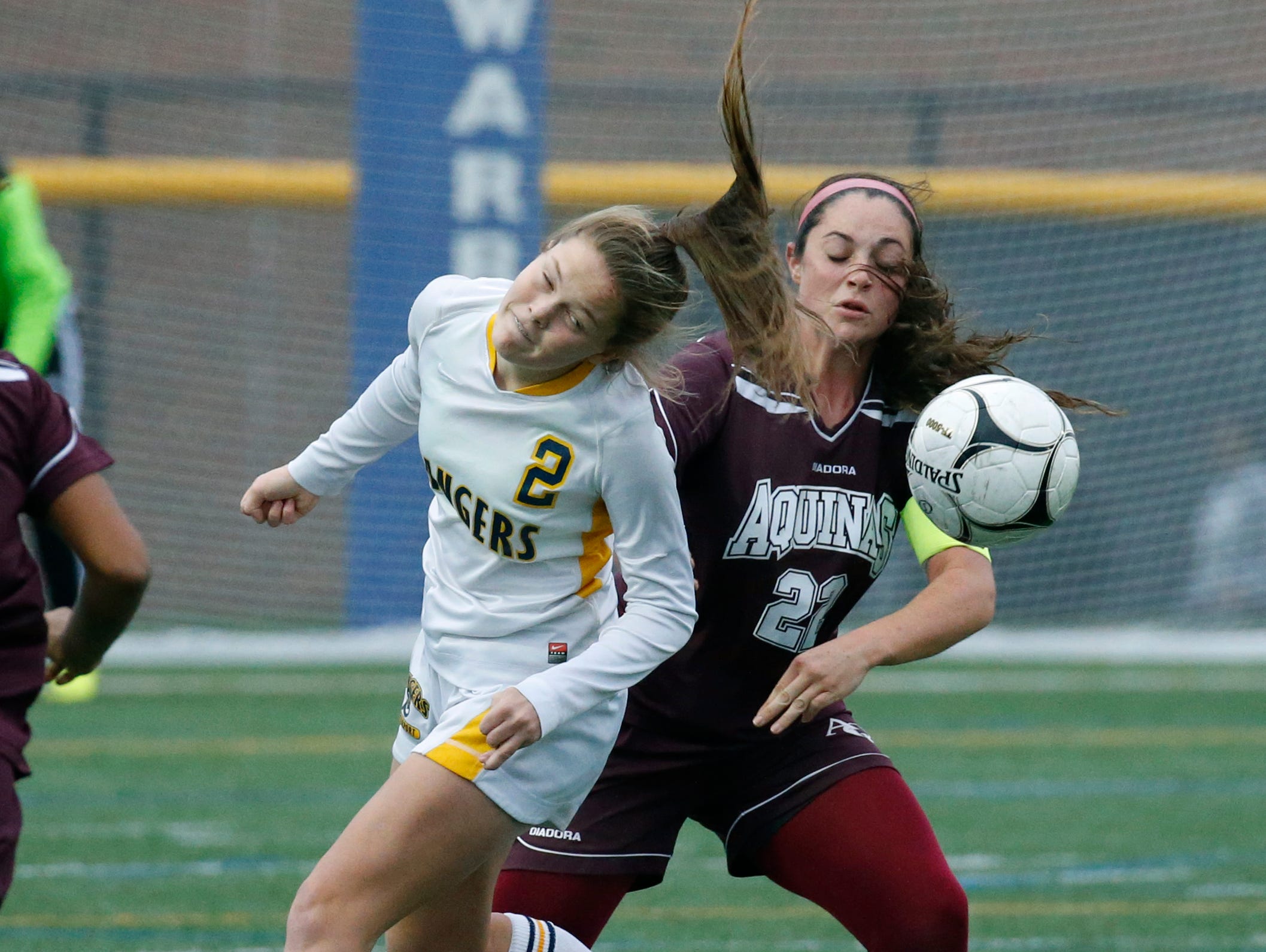Spencerport's Erin Coykendall and Aquinas' Regan Nugent in the first half at Webster Schroeder High School.