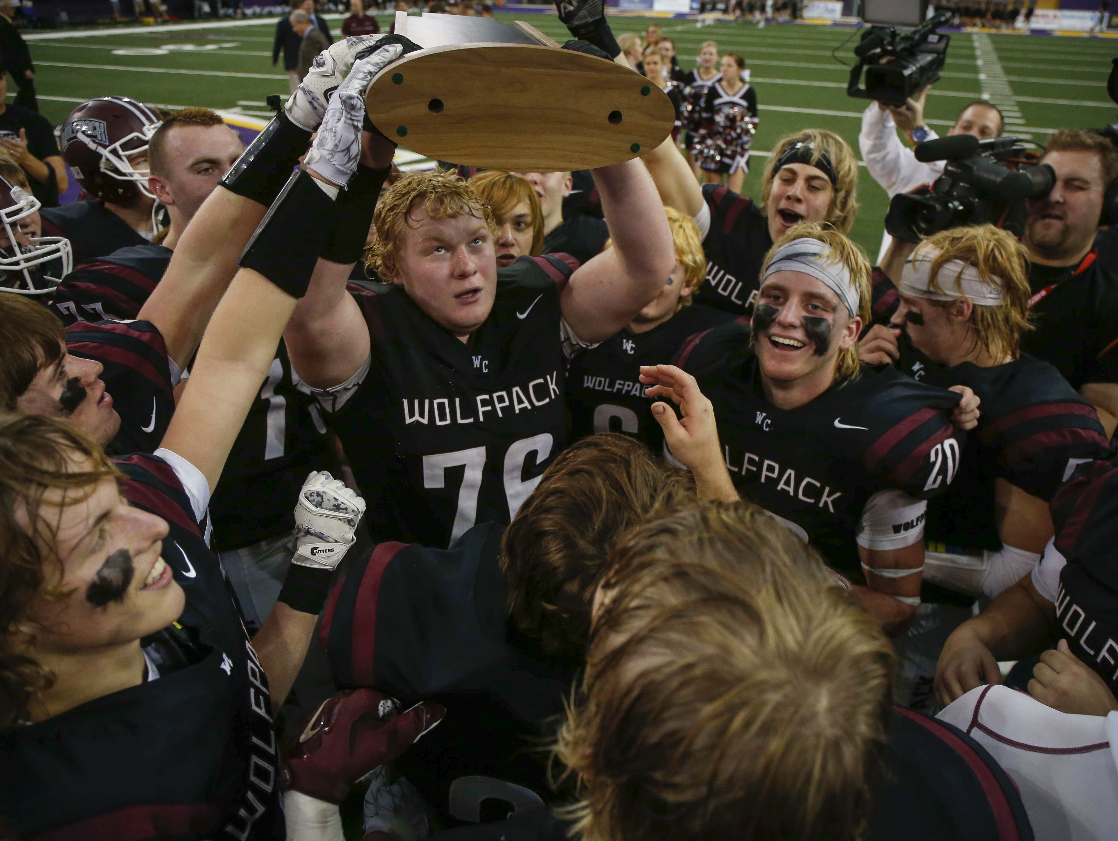 Members of the Western Christian football team celebrate a win over Iowa City Regina on Friday, Nov. 18, 2016, during the 2016 Iowa high school Iowa Class 1A football championships at the UNI-Dome in Cedar Falls.