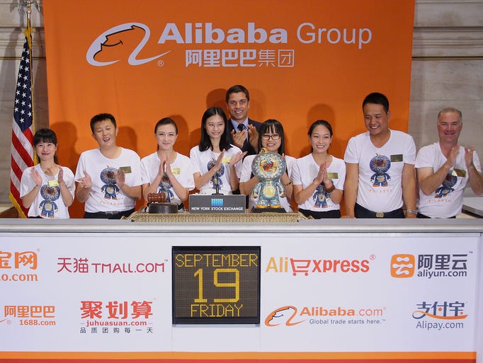 Representatives from Alibaba ring the opening bell as they launch their initial public offering of stock at the New York Stock Exchange.
