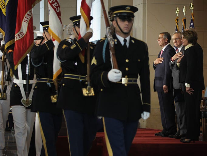 A color guard passes Speaker of the House Rep. John Boehner, R-Ohio, Senate Majority Leader Sen. Harry Reid, D- Nev., and House Minority Leader Rep. Nancy Pelosi, D-Calif., during a Congressional Gold Medal presentation ceremony at the Emancipation Hall at the U.S. Capitol Visitors Center on Capitol Hill on Wednesday. The medal was award men and women who were killed during the Sept. 11, 2001, terror attacks for their heroic sacrifices.