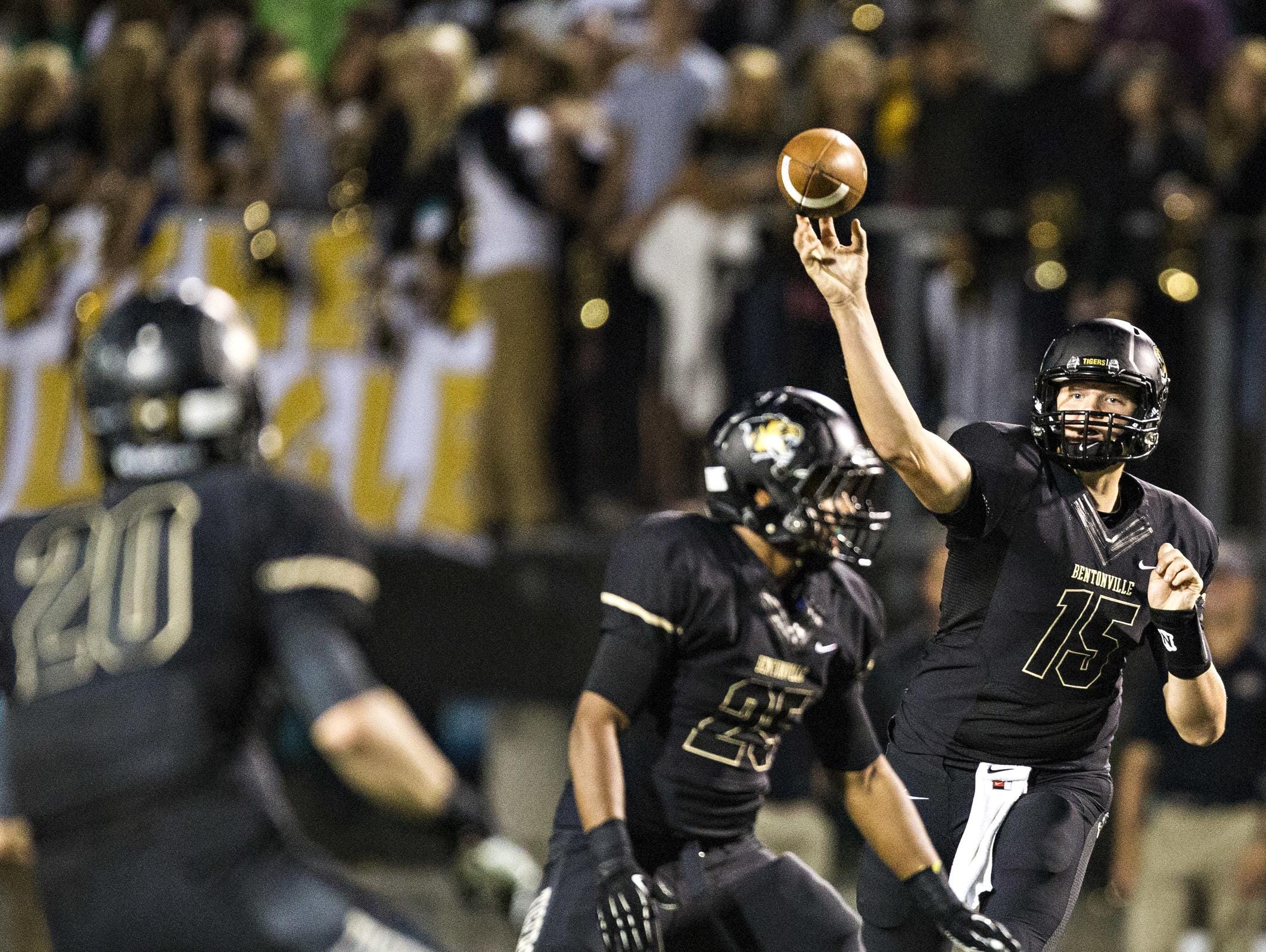Bentonville High quarterback Kasey Ford makes a throw during a 2013 game. Ford is now an experienced player leading a 2-0 team with back-to-back state titles.