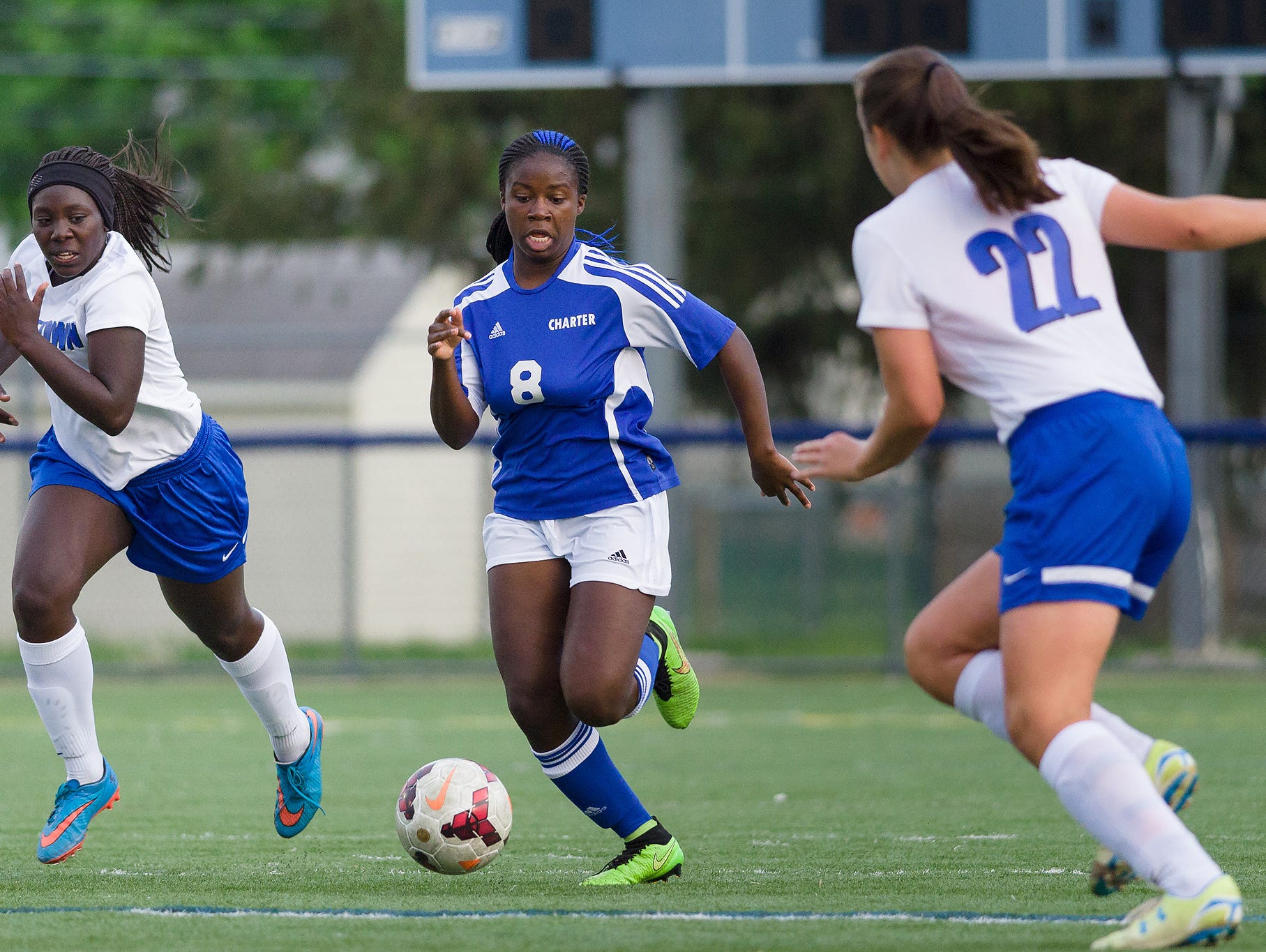 Sheyenne Allen (8) of Charter drives the ball past Mary Warren (22) of Middletown in a Charter at Middletown girls soccer game on Wednesday.