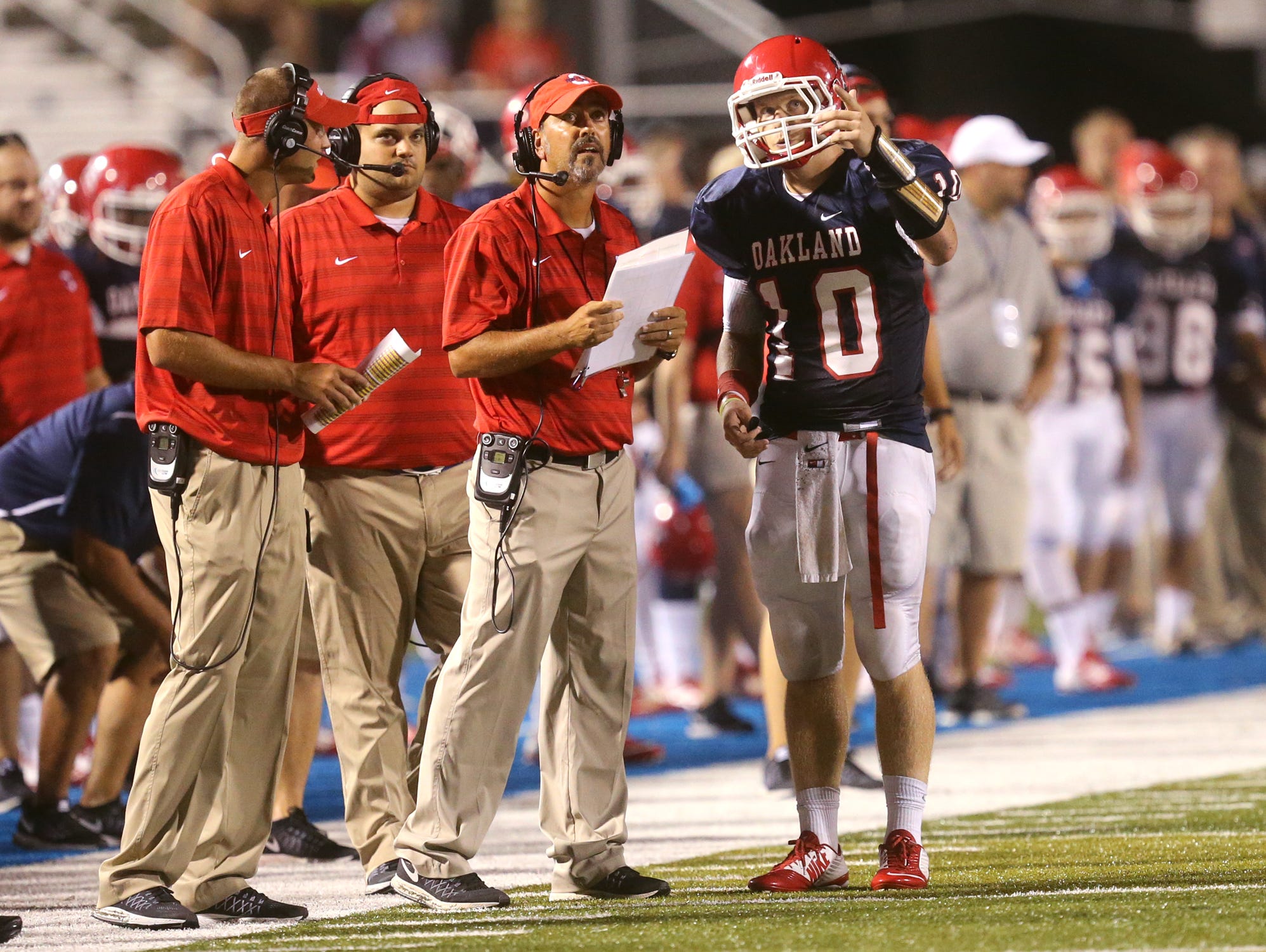 Oakland's quarterback Brendon Matthews (10), talks with the head coach Kevin Creasy during the game against Hoover at the Middle Tennessee Classic at MTSU's Floyd Stadium, on Saturday, Aug. 22, 2015.
