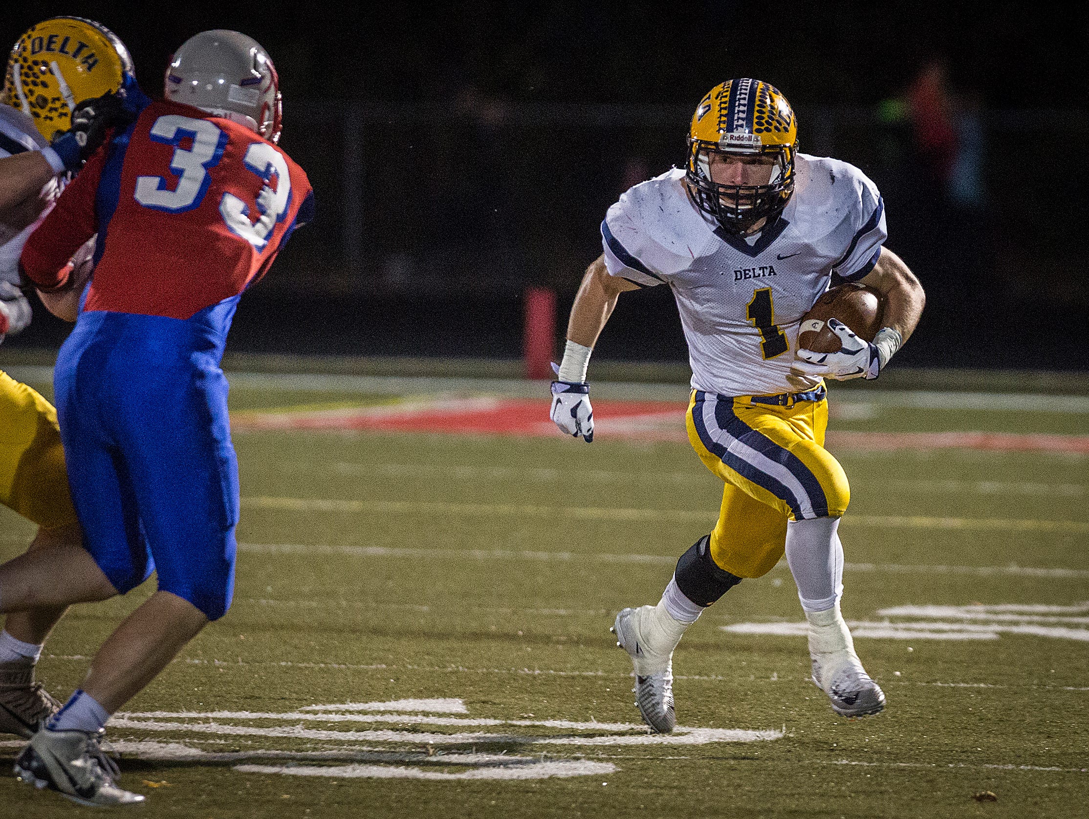 Delta's Zach Mills looks for an opening in Roncalli's defense during their regional game at Roncalli High School on Friday, Nov. 13, 2015.
