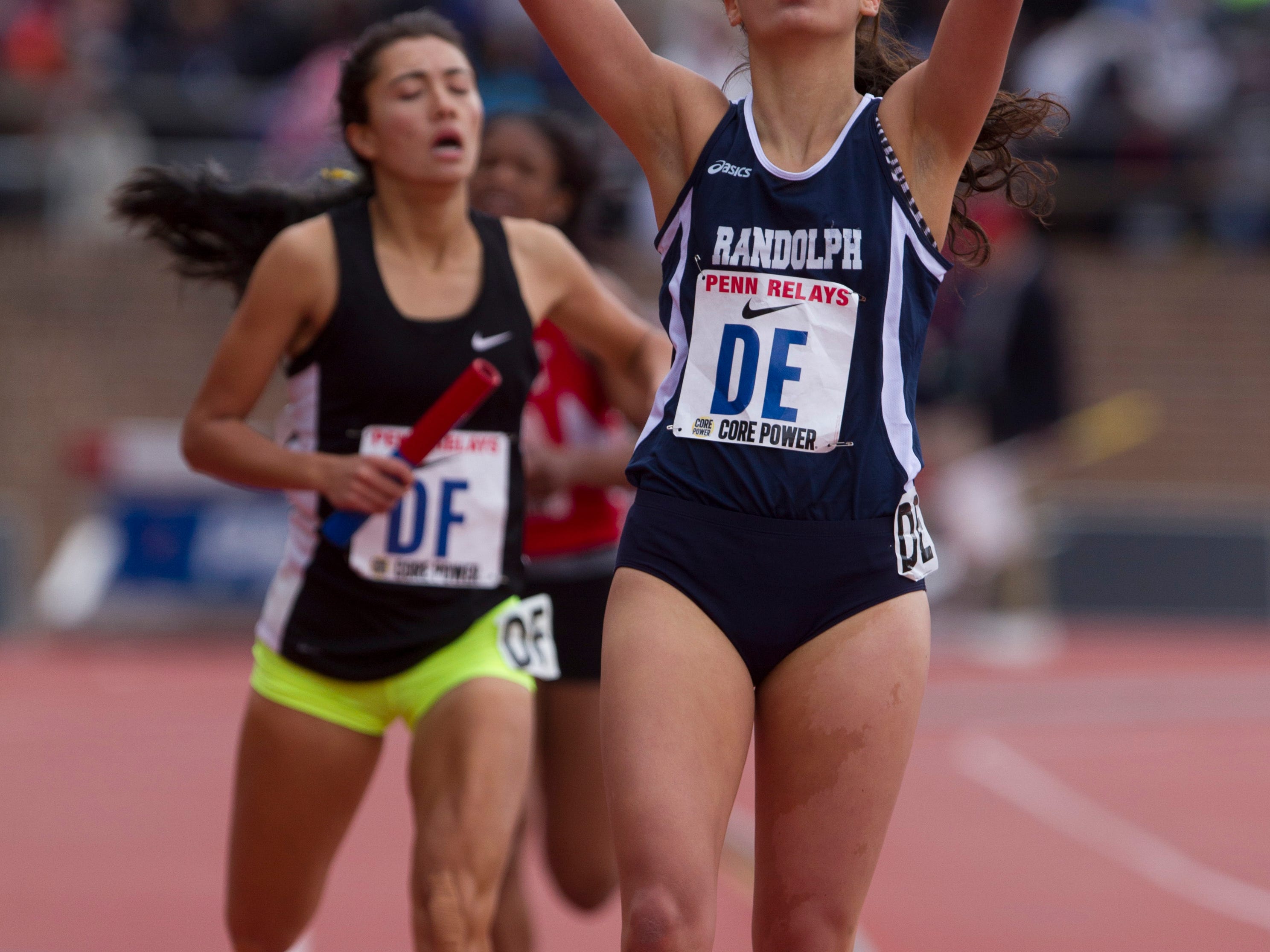 Randolph senior Liz Lansing points skyward as she crosses the finish line in a large-school 4x800 heat on Thursday at Penn Relays.