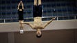 North Korean athletes practice on a trampoline.