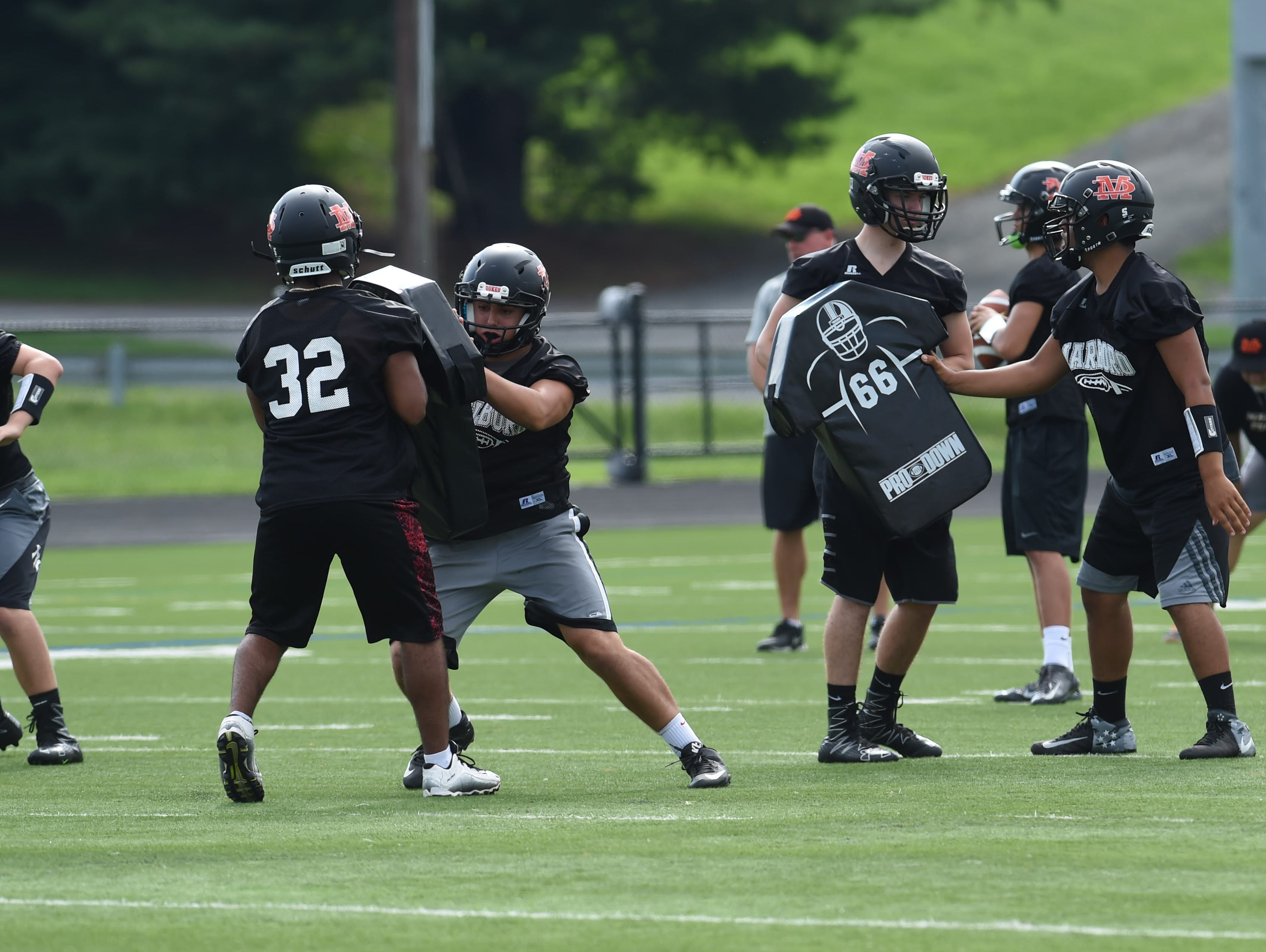 Junior Nico Ramos, left, blocks a teammate during football preseason practice at Marlboro High School.