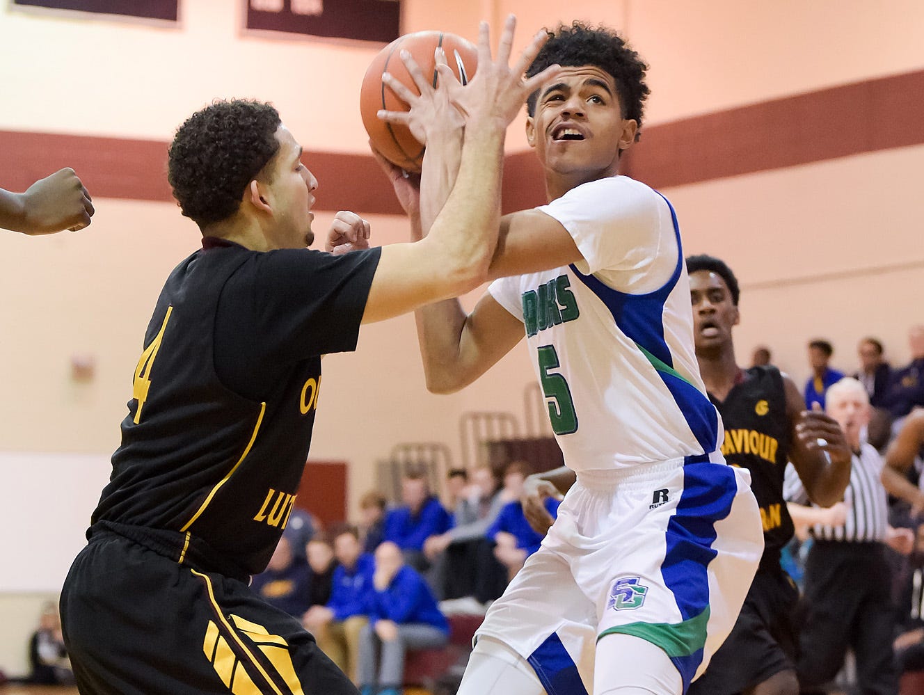 Mark Harris (No. 5) of St. Georges Technical High School tries to get the ball to the net.