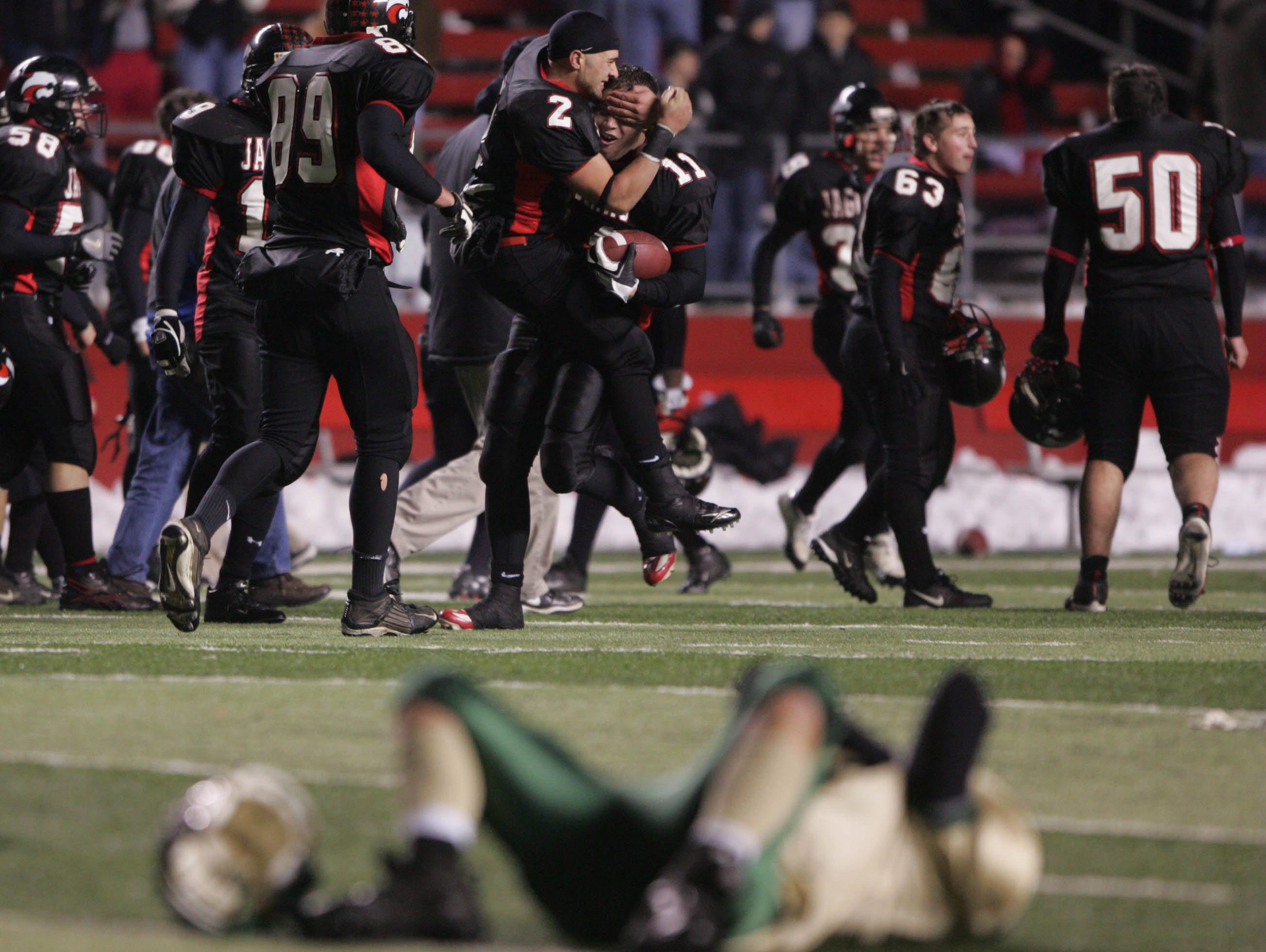 Jackson Memorial's Mark Schiavone (2) and Bobby Cole (11) celebrate in front of a devastated Brick Memorial player ten years ago.