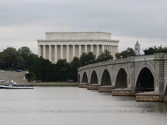 A boat passes under the drawbridge span of Memorial