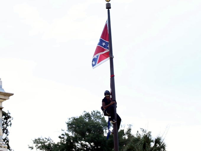 Activists take down the Confederate flag at the SC
