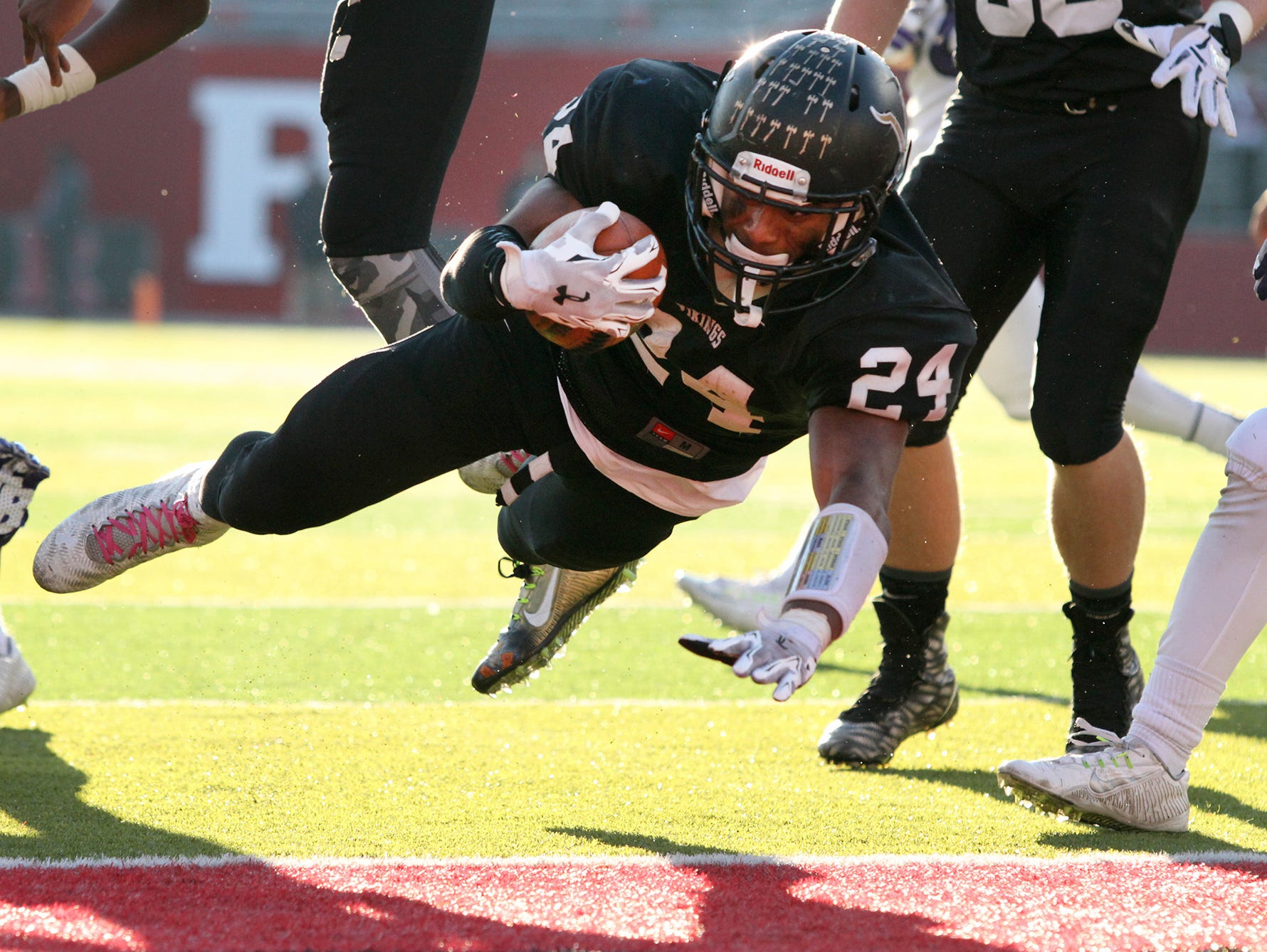 South Brunswick's #24 Phil Campbell dives into the end zone for a touchdown during the second half of the game. South Brunswick defeated Old Bridge in the Central Group V football championship, Piscataway, NJ, December 5, 2015. Mary Iuvone/For The Home News