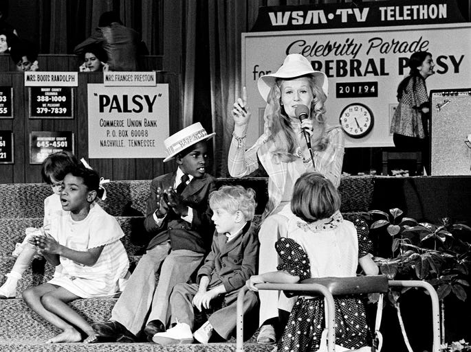 Honorary Cerebral Palsy telethon chairman singer Lynn Anderson chats with some victims of the disease who may benefit from the money raised at the WSM-TV United Cerebral Palsy Telethon on March 11, 1973, at Municipal Auditorium.