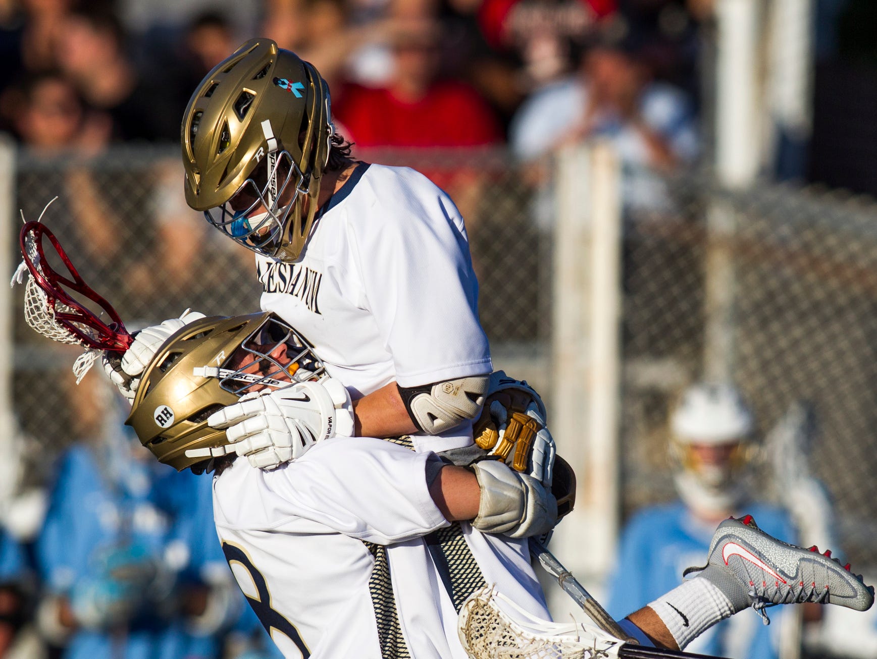 Salesianum's Michael Drake leaps into the arms of teammate Michael Sanzone after scoring a goal in the first half of the DIAA Boys Lacrosse Championship game at Caravel Academy on Saturday night. Salesianum defeated Cape Henlopen by a score of 16-5.
