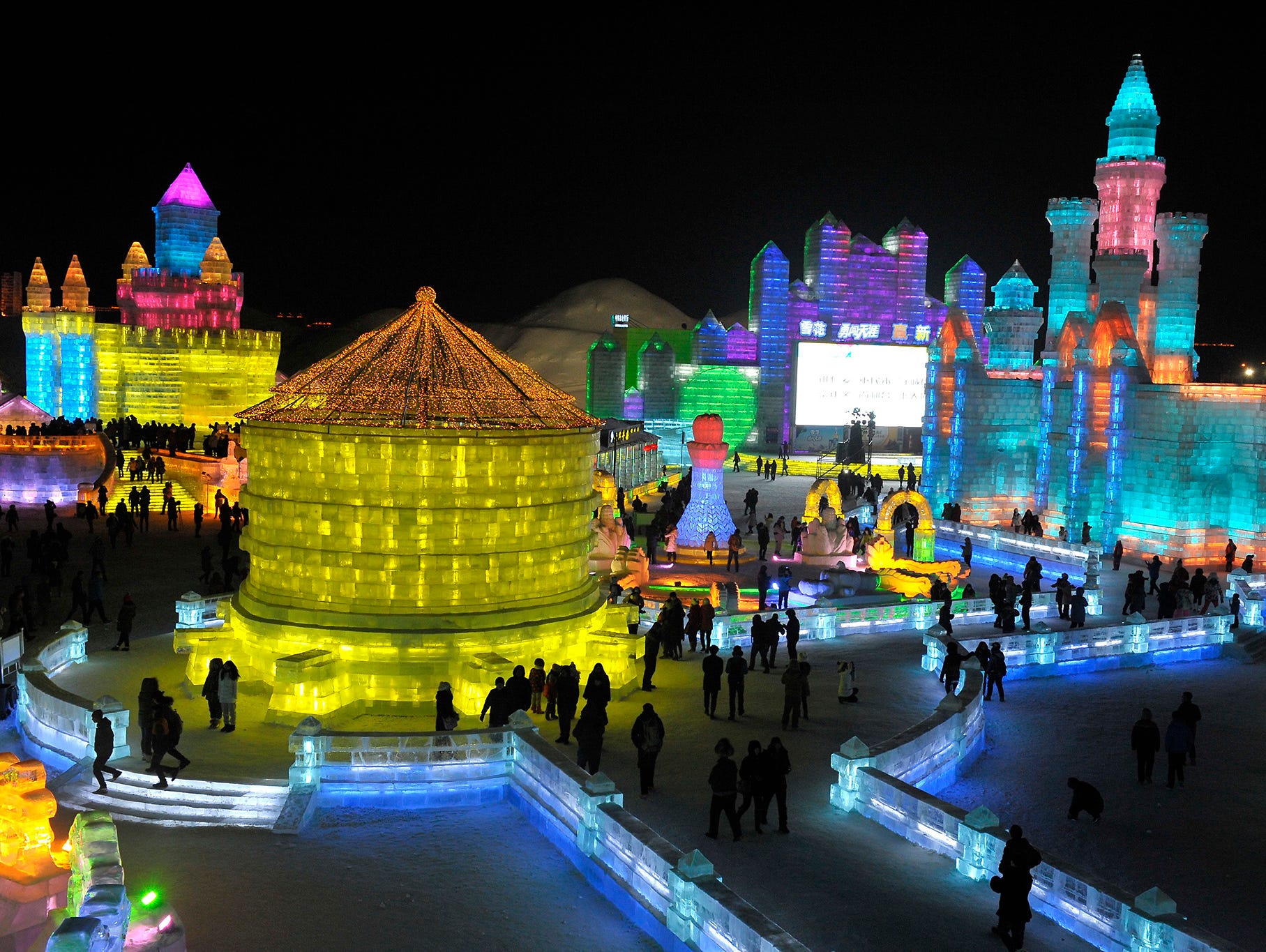 epa04547328 People tour between the large-scale ice sculptures at the Ice and Snow World in Harbin city, Heilongjiang province, China, 05 January 2015. The 31th Harbin International Ice and Snow Festival kicks off on 05 January that will last about t