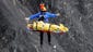 A rescue worker is lifted into an helicopter at the