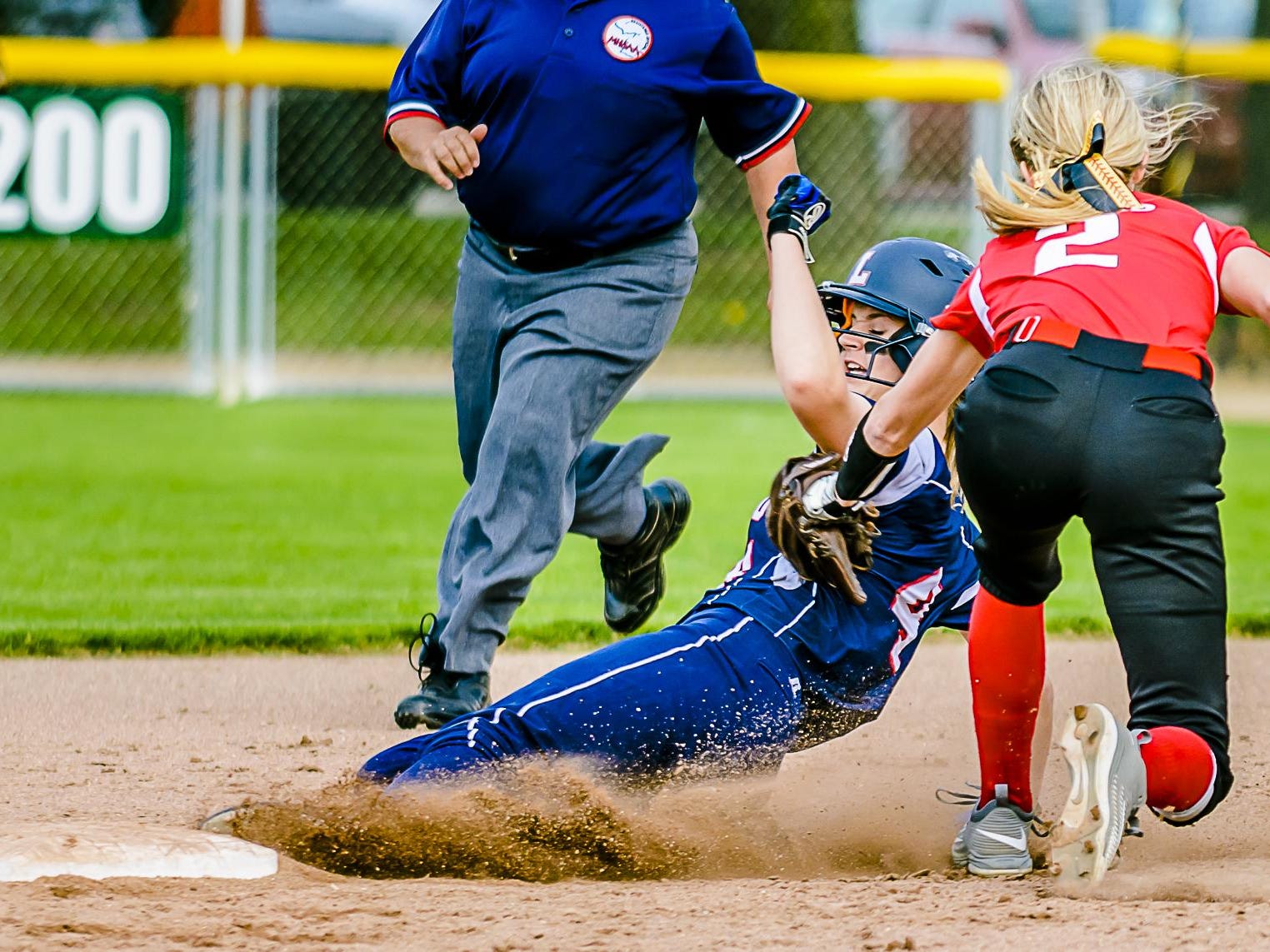 Maranda Barton ,bottom, of Lakewood beats a tag by Katie Eppard ,2, of Laingsburg to steal 2nd in the 6th inning of their Softball Classic first round game Tuesday May 17, 2016 at Ranney Park in Lansing. KEVIN W. FOWLER PHOTO