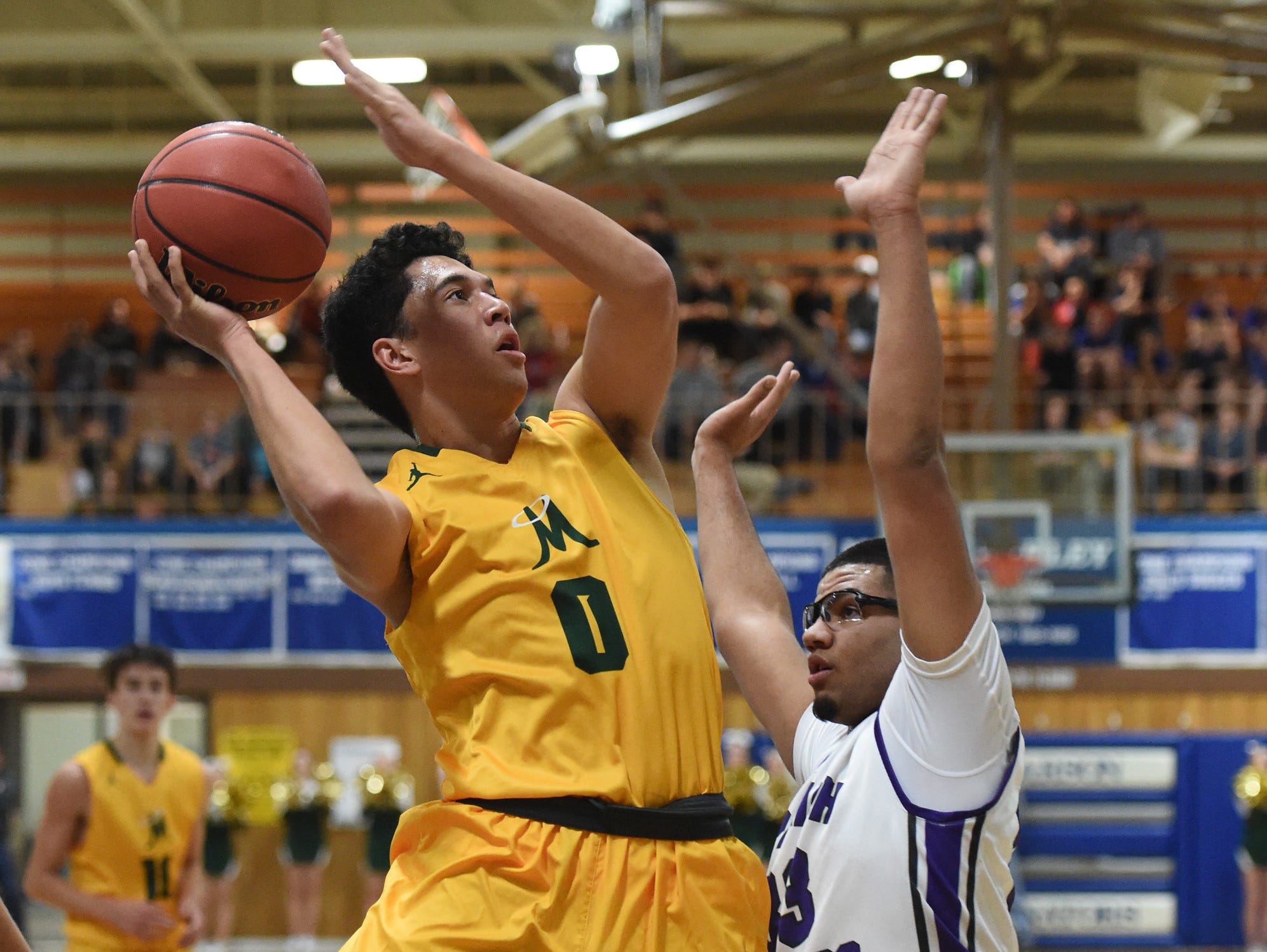 Bishop Manogue's Brevon Bansuelo goes up to shoot with Spanish Spring's Marcus Loadholt covering him in Thursday's at Carson.