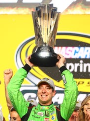 Kyle Busch lifts the Sprint Cup, awarded the winner