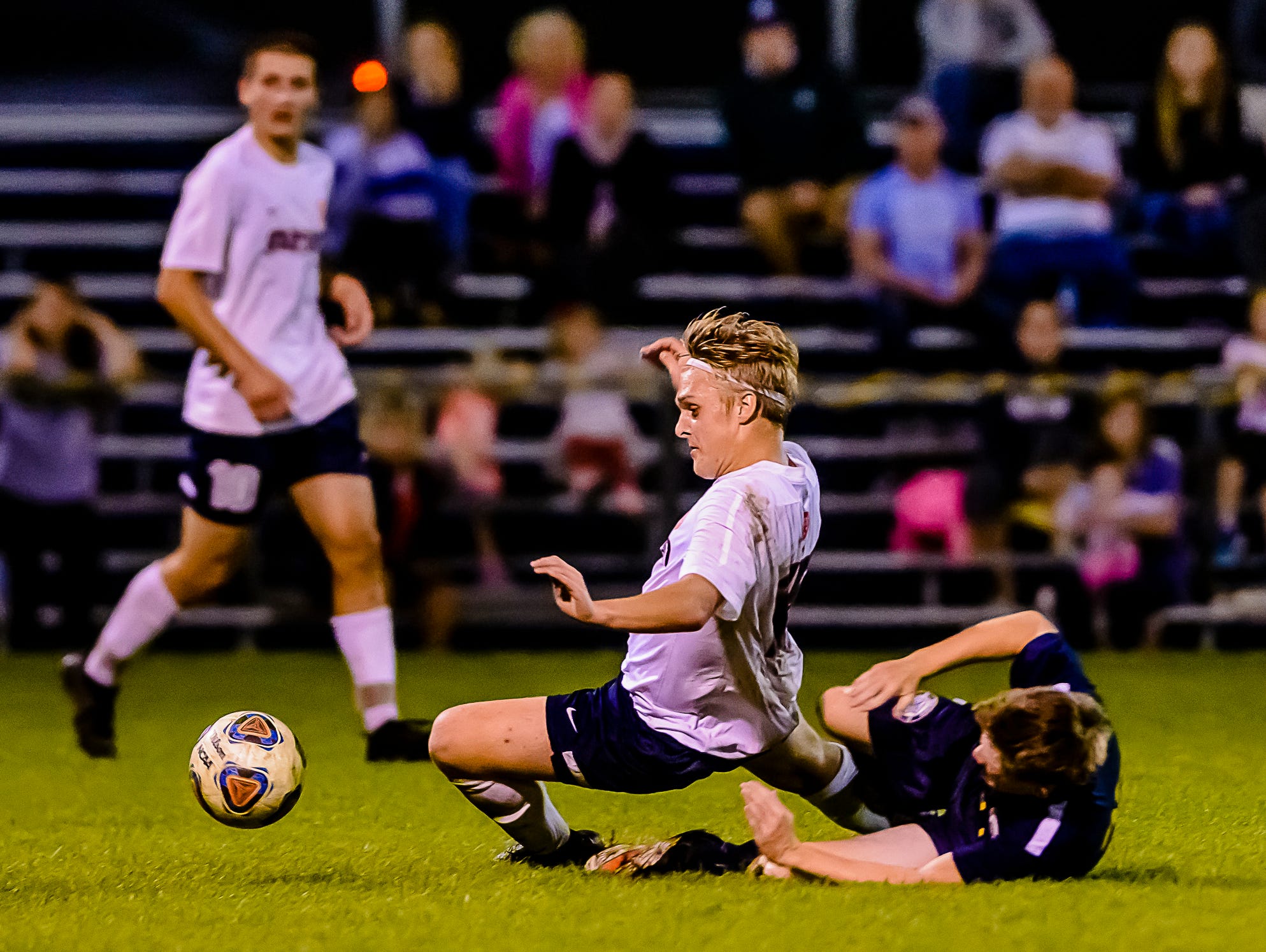 Caleb Graham ,center, of Mason is taken down by a Chelsea defender in the last minute of their Division 2 District first round game Monday October 17, 2016 in Mason. Mason would get a free kick and that would be one of their last best chances to level the score. KEVIN W. FOWLER PHOTO