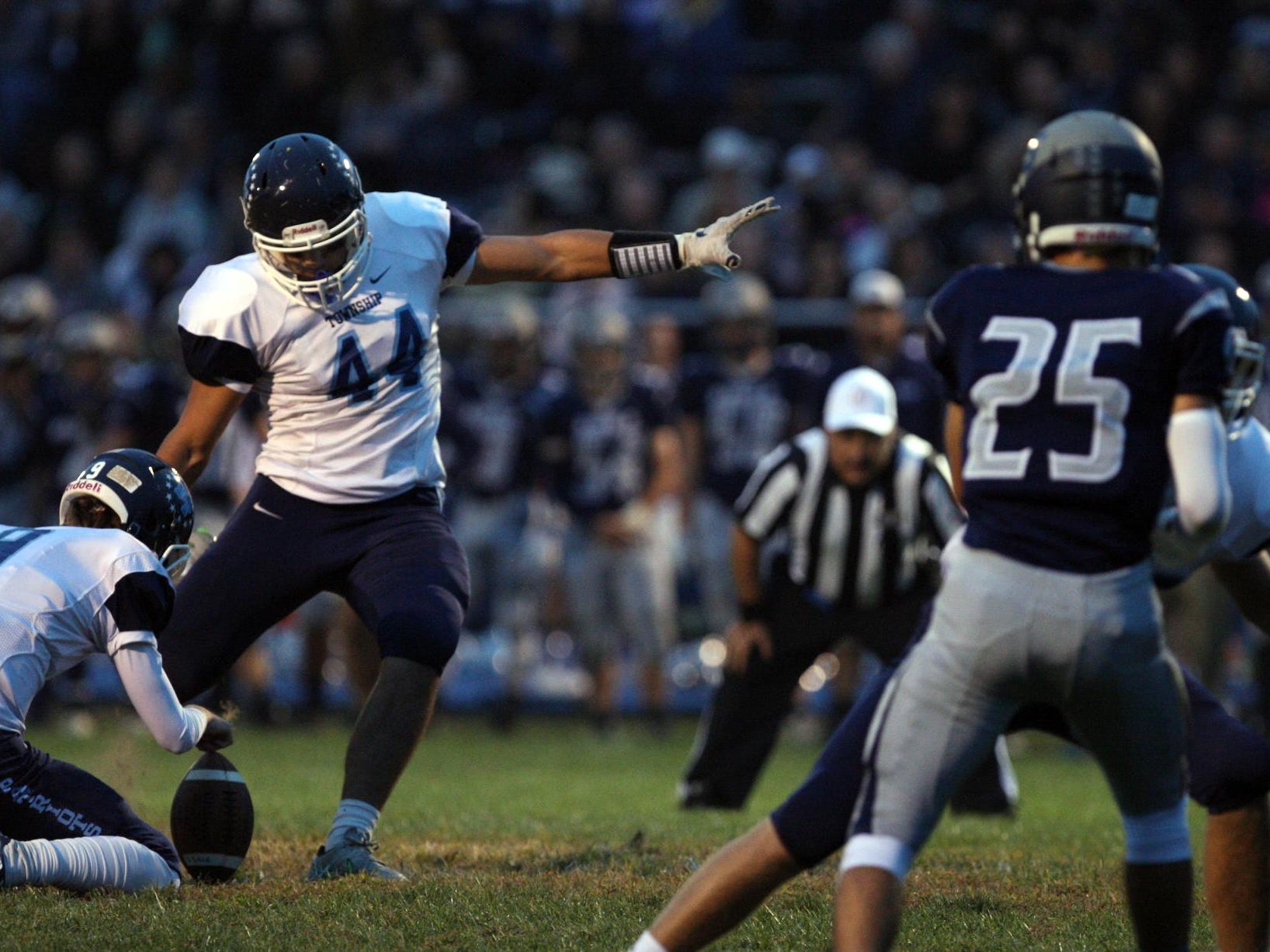 Nick Galenti, #44 Freehold Township, kicks a successful extra point with holder Kevin Doherty, #9, as they play Howell in a football game Friday, September 25, 2015, at Howell High School.