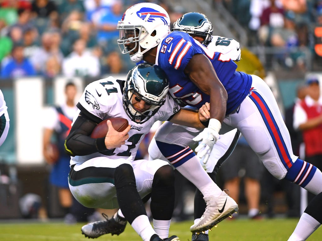 Philadelphia Eagles quarterback Carson Wentz , left,  is sacked by Buffalo Bills defensive end Jerry Hughes during the first quarter at Lincoln Financial Field.