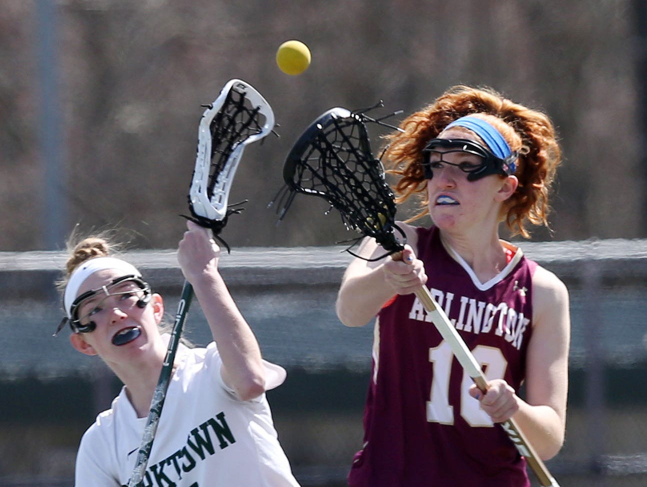 From left, Yorktown's Ciara Frawley (5) and Arlington's Abby Carlin (10) battle for ball control during girls lacrosse action at Yorktown High School March 26, 2016. Yorktown won the game 14-5.